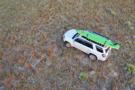 Halsey, NE, USA - September 23, 2020: Toyota 4Runner SUV (2016 trail model) with an inflatable touring stand up paddleboard in Nebraska Sandhills, aerial view.のeditorial素材