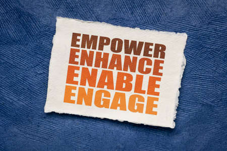 motivational leadership, coaching or business concept - empower, enhance, enable and engage, word abstract on handmade paperの写真素材
