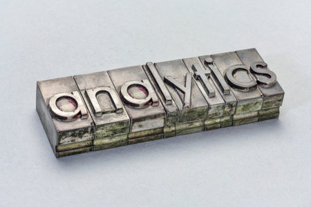 analytics word ingrunge metal type printing blocks over textured paper, business data conceptの写真素材