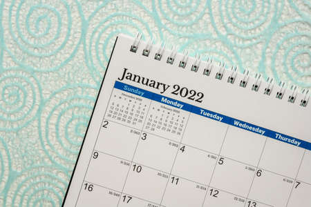 January 2022 - spiral desktop calendar  against winter abstract paper, New Year, time and business conceptの写真素材