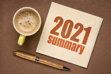 2021 year summary text on a napkin with a cup of coffee, end of year business conceptの写真素材