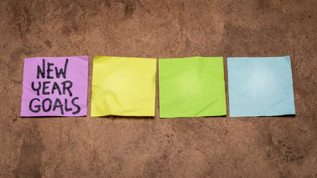 New Year goals - row of colorful blank sticky notes, setting goals and resolutions concept