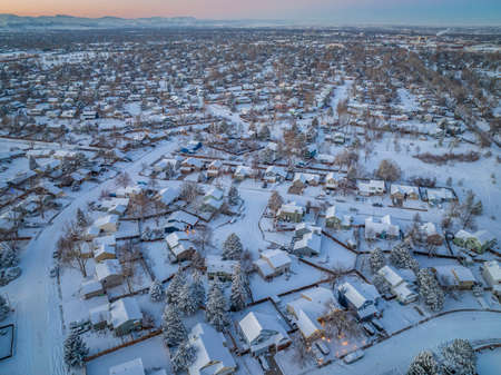 winter dusk over residential area of Fort Collins in northern Colorado after snowstorm, aerial viewの写真素材