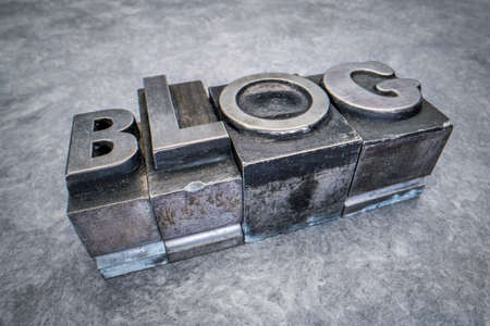 blog word abstract in gritty vintage letterpress metal types against textured handmade paper, mixed fonts, social media and communication conceptの写真素材