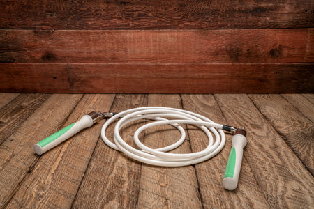 heavy fitness jump rope on rustic, weathered wood backgroundの写真素材