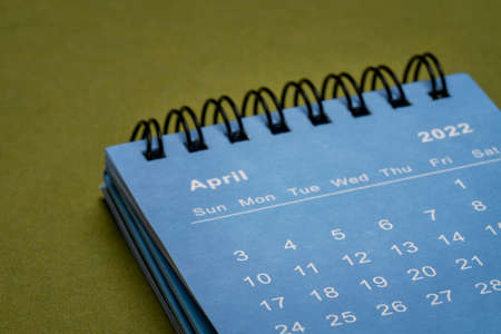 April 2022 - spiral desktop calendar, time and business conceptの写真素材