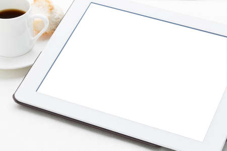 mockup of digital tablet with a blank isolated screen (clipping path included), with a cup of coffee