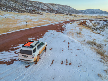 Fort Collins, CO, USA - February 17, 2022: Dirty Toyota 4Runner SUV on a muddy ranch road at winter...