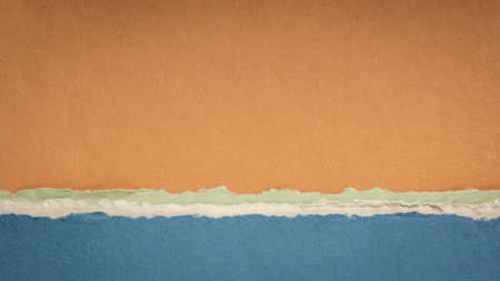 abstract landscape in blue and orange pastel tones - a collection of handmade rag papersの写真素材