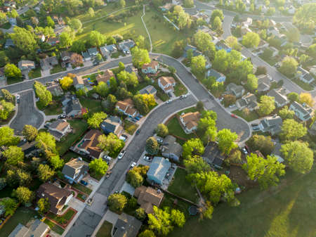 spring sunrise over residential area of Fort Collins in northern Colorado with streets after asphalt crack sealing, aerial viewの写真素材