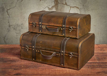 retro suitcase or storage box on wooden rustic table, set of twoの写真素材