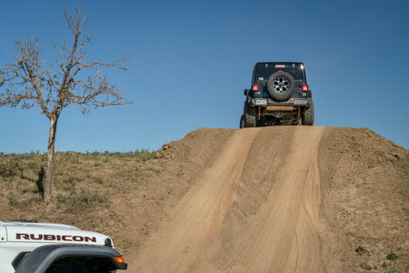 Loveland, CO, USA - August 27, 2022: Jeep Wranglers on a training drive off-road course approaching a steep hill.のeditorial素材