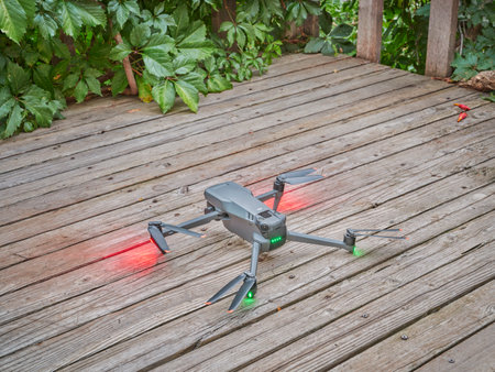 Fort Collins, CO, USA - September 13, 2022: DJI folding quadcopter drone is taking off from a backyard deck or patio at summer dawn.のeditorial素材