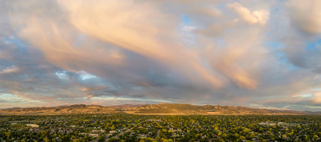 early morning over Fort Collins and foothills of Rocky Mountains in northern Colorado, aerial panorama with dramatic cloudsの写真素材