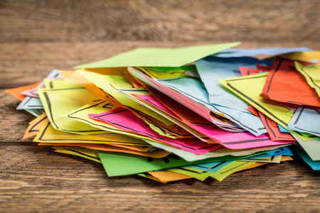 pile of reminder sticky notes on a rustic wooden tableの写真素材
