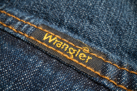 Fort Collins, CO, USA - November 14, 2022: Closep of Wrangler label on a trucker denim jacket. Wrangler is American manufacturer of jeans and other clothing.のeditorial素材