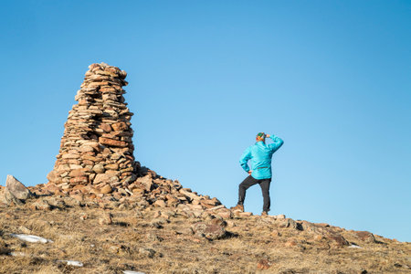 hiker and large stone cairn overlooking Colorado prairie, Soapstone Prairie Natural Area near Fort Collinsの写真素材