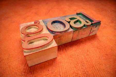 goal word in vintage letterpress wood type against orange textured paper, business, education and...