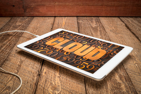 cloud computing concept - word in vintage letterpress wood type against numbers on a digital tabletの写真素材