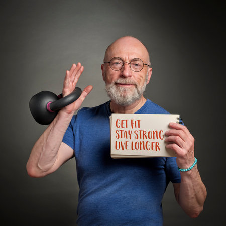 get fit, stay strong, live longer - motivational note held by a senior man exercising with a kettlebellの写真素材