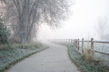 northern Colorado bike trail in fog - November morning on the Poudre River Trail near WIndsorの写真素材