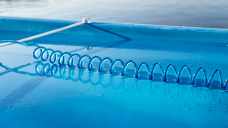 coiled safety leash on a wet deck of stand up paddleboardの写真素材