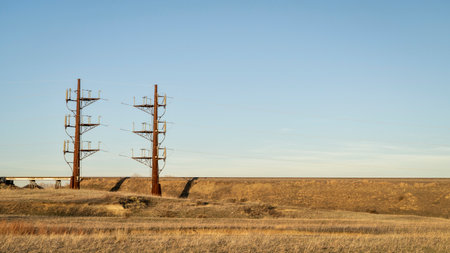 industrial landscape of northern Colorado with a power line and railroad, early springの写真素材