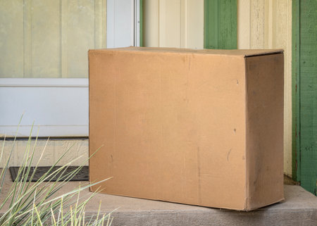 big package at a house doors - mail order and home delivery concept