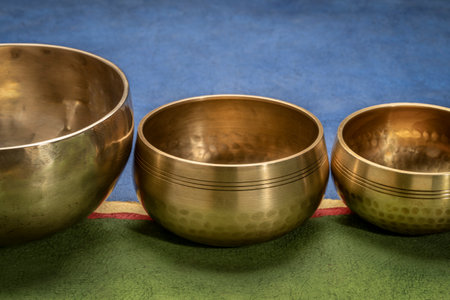 handmade Tibetan singing bowls against abstract paper landscape, sound therapy for healing, relaxation and meditationの写真素材