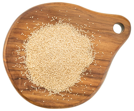 gluten free amaranth grain on a mini wooden cutting board isolated on whiteの写真素材
