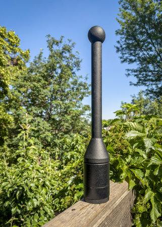 adjustable weight steel club on a wooden backyard deck, summer sceneryの写真素材