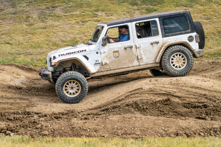 Loveland, CO, USA - August 26, 2023: Jeep Wrangler, Rubicon model, on a muddy and bumpy training drive off-road course.のeditorial素材