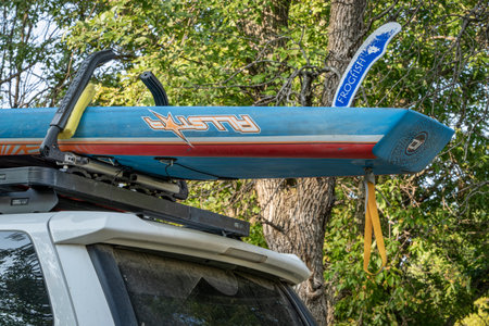 Halsey, NE, USA - September 9, 2023: Racing stand up paddleboard by Starboard with Frogfish pivoting fin for shallow water paddling on roof racks of  Toyota 4Runner SUV.のeditorial素材