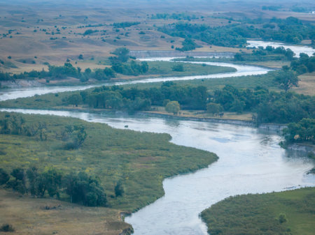 dawn over Dismal River meandering through Nebraska Sandhills at Nebraska National Forest, aerial...