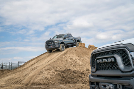Loveland, CO, USA - August 26, 2023: RAM Rebel trucks on a muddy training off-road trail course.のeditorial素材