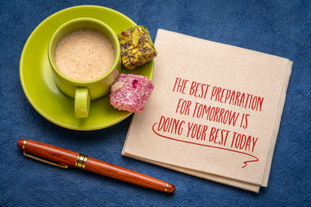 The best preparation for tomorrow is doing your best today - handwriting on napkin with a cup of coffeeの写真素材