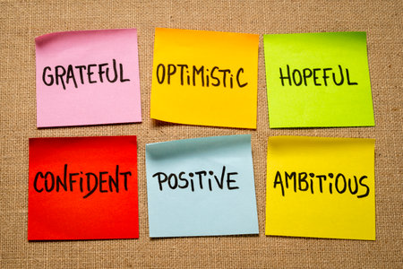 inspirational power words - grateful, optimistic, hopeful, confident, positive and ambitious - set of sticky reminder notes against burlap canvasの写真素材