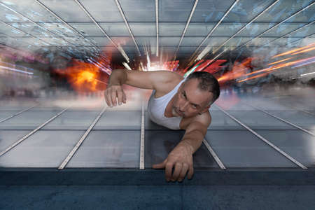 a man pulls himself up against a wall