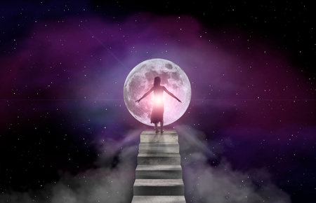A young woman stands on a concrete staircase and looks into the full moonの写真素材