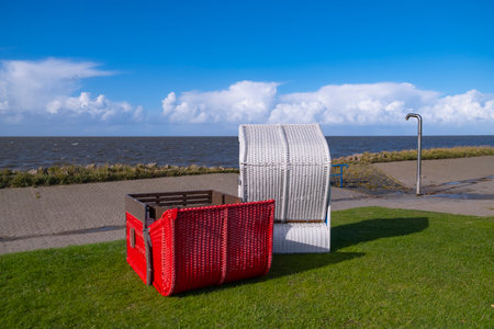 Beach chairs on the North Sea coast, one is lying on its backの写真素材