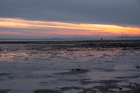 Low tide in Schillig on the North Sea during a sunriseの写真素材