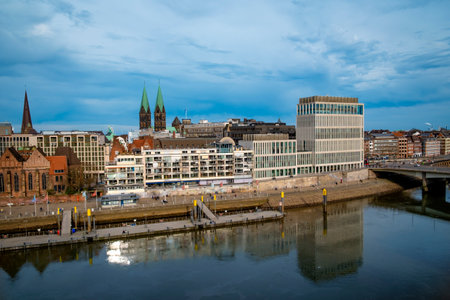 Weser promenade in Bremen with cathedral and skyline under blue skyの写真素材