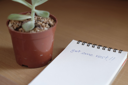 Get some rest message on office desk.の写真素材