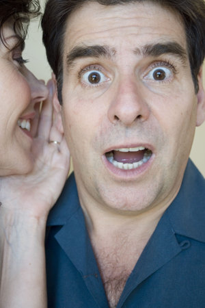 Woman whispers in his ear and he is surprised