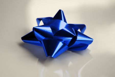 Blue bow isolated and contrasted over silver background.の写真素材