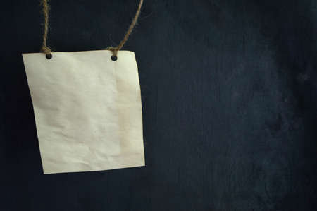 Old paper sheet on rope on gray background.の写真素材