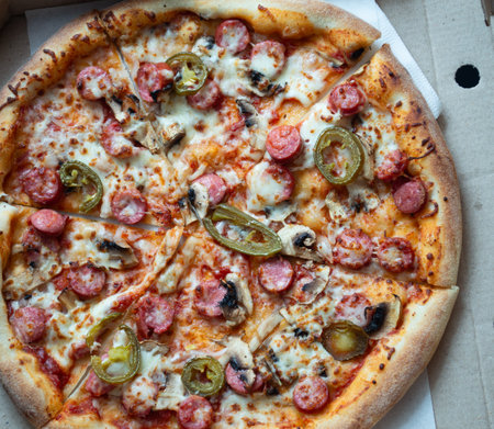 Sausage and jalapeno pizza in a boxの写真素材