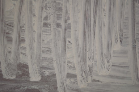 Strokes of white paint on a wooden surfaceの写真素材