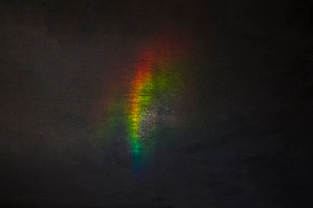 Rainbow reflection on a dark wall