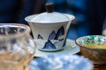 Traditional Chinese porcelain teapot and cups on the table